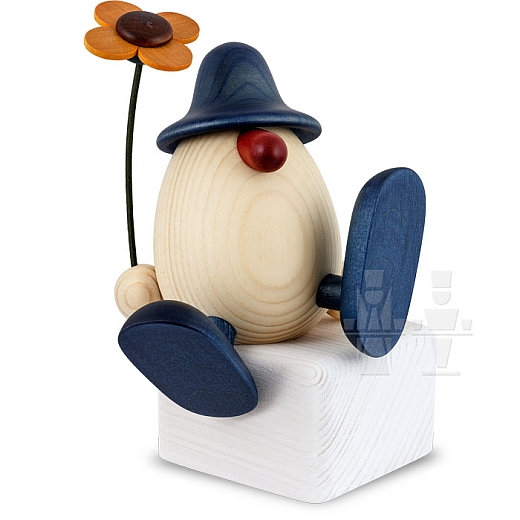 Egghead Alfons with flower sitting on edge or dancing blue