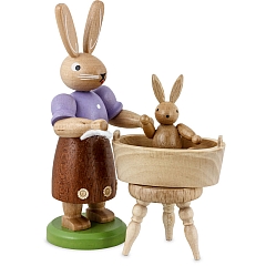 Easter bunny mother with little child have a bath, small colored-stained