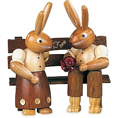 Easter bunny couple on garden bench, small natural